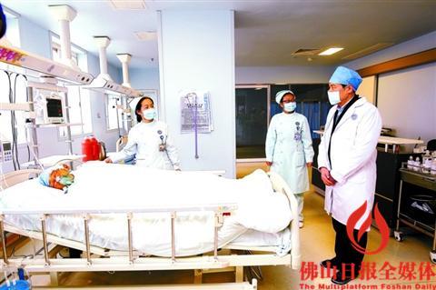 中国侨网昨日，副市长乔羽（右一）到医院看望王文田，向医护人员了解治疗情况。/佛山日报记者张弘弢摄