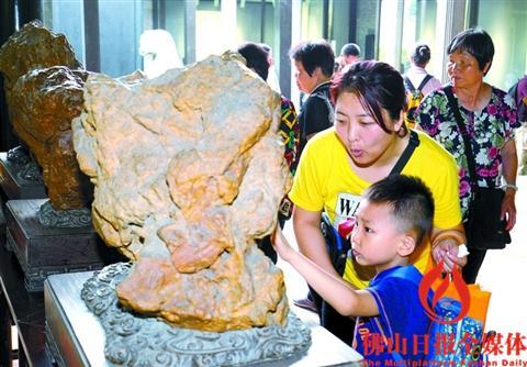 中国侨网一位市民带小朋友在梁园参观石展。佛山日报记者 甘建华 摄