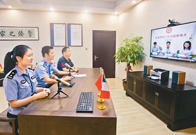 中国侨网民警在温州市瓯海区“在线警侨工作室”,与法国联络点联络员进行视频通话。(来源:温州网)