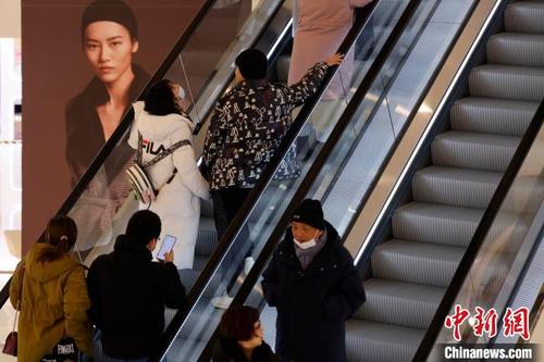 中国侨网民众戴着口罩在商场内逛街。　殷立勤　摄