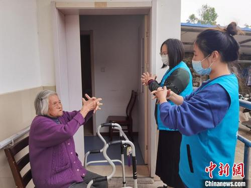 中国侨网支老人员教老人做手指操。 倪妮 摄