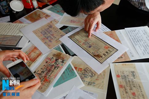 日本宣布投降69周年前夕，重庆民间收藏人向记者展示了近万张抗战金融票据