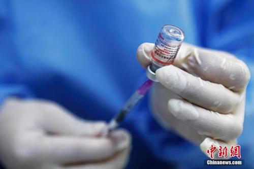 中国侨网资料图：医护人员正在用注射器抽取药液。中新社记者 殷立勤 摄