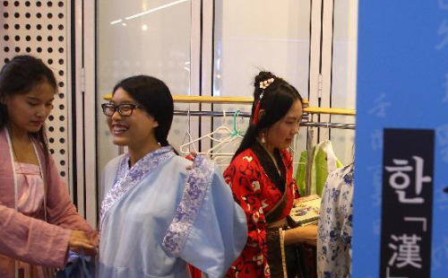 中国侨网韩国首尔,几名女士在活动现场试穿中国传统汉服。(新华社 姚琪琳 摄)