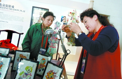 中国侨网在国家会议中心“这里是北京”主题展览展示区,北京非遗中心的工作人员正在布置“北京皮影戏”展台。(方非 摄)