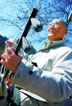 中国侨网又是春风拂面时，张老拿起心爱的京胡来到附近的公园，暖阳下，转弓、抖弓、揉弦……一遍遍练习演奏技艺，摸索不同的指法和演奏技巧。（方非 王巧星/摄）