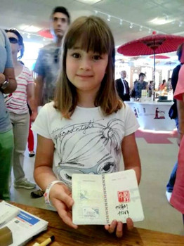 中国侨网意大利小女孩展示获得的中国印。(意大利欧联通讯社)