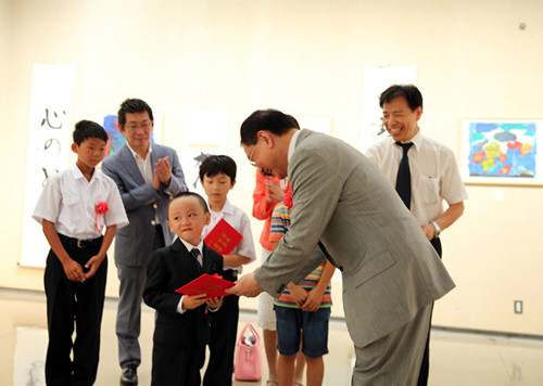 向获奖青少年代表颁发证书,中间的小男孩才5岁。(日本《中文导报》)