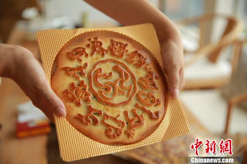 台湾象形文字专家麦智明推出象形月饼，古老的象形文字“享”在中间，四周围绕着十二生肖的象形文字。(董子畅