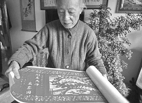 陈国章老人展示他的百米刀刻作品