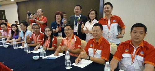 黄文辉夫妇（后排左三起）与钟家东为参赛者鼓励打气。（马来西亚《南洋商报》）