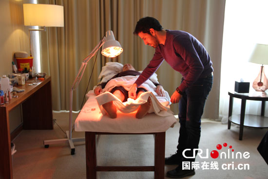 乌萨马在给患者做治疗。(摄影