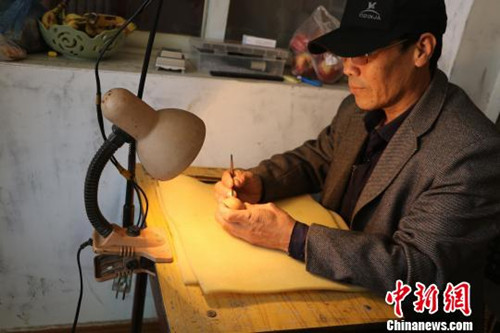 中国侨网李世华正在进行雕刻。(张春娥 摄)
