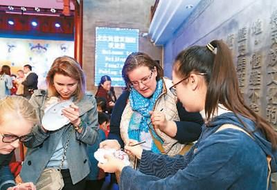 中国侨网图为外国友人体验手绘京剧脸谱。（马柯 摄）
