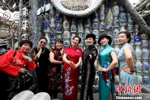 中国侨网资料图:身着旗袍的女士们在瓷房子前自拍。张道正 摄