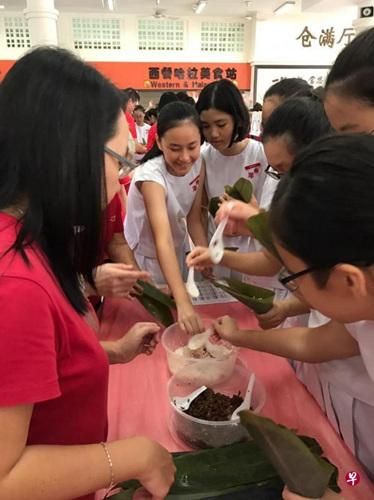 中国侨网新加坡南洋女中的中一学生们在包粽子。（新加坡《联合早报》资料图）