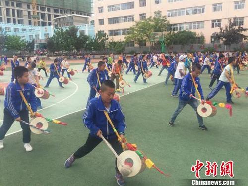 中国侨网图为皋兰石洞小学的3年级学生放学后，跑去操场上练习国家非物质文化遗产太平鼓。　史静静　摄