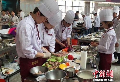 中国侨网参赛大厨在精心准备菜肴　张瑶　摄