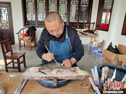 中国侨网毛笔制作工序“梳绒”。 吕婕 摄