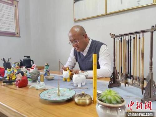 中国侨网张学义多年来以手艺人之技，守“旧”推“新”，将戏曲脸谱雕绘在石膏上，赋予“黎侯彩雕”新的生命。　受访者供图