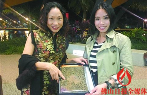 汤斯维尔市华侨会负责人利文(左)对“佛山印象”礼盒里的香云纱颇感亲切。