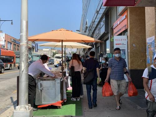 中国侨网新世界商城餐馆业者在人行道上设摊营业。（美国《世界日报》/赖蕙榆 摄）