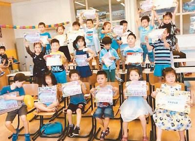 中国侨网荷兰代尔夫特中文学校的学生举起奖状。