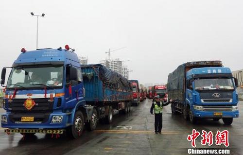 中国侨网2月23日，海南海口，执勤人员在海口新海港指挥车辆进港。　尹海明 摄
