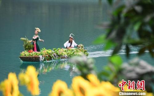 中国侨网夏日时节，白马人乘坐小船在天池中一展歌喉。　杨艳敏　摄